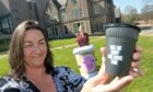 Tara Jaffray, owner of Corner on the Square in Beauly with one of the reusable cups, and Catherine Gee, deputy chief executive of Keep Scotland Beautiful. Image: Sandy McCook/DC Thomson.