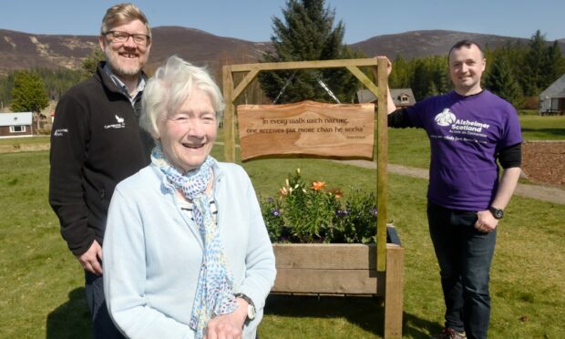 Christine Macdonald of Aviemore pictured with Grant Moir, chief executive of the cairngorms National Park and Kenny Wright, outdoor resource centre co-ordinator unveiling a new plaque on the grounds. Image: Sandy McCook/ DC Thomson.