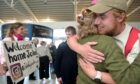 John Prendergast gives his mum Amanda a big hug at Inverness Airport. Image: Sandy McCook/DC Thomson