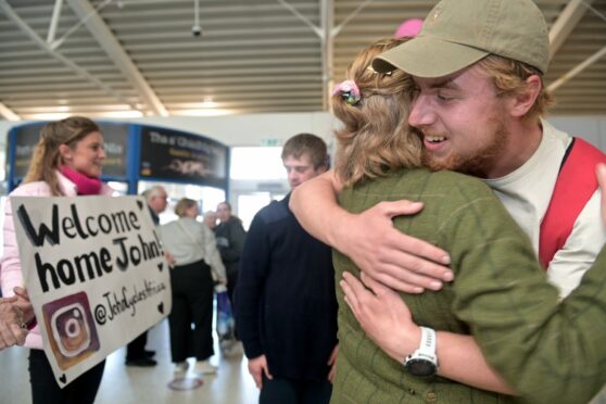 John Prendergast gives his mum Amanda a big hug at Inverness Airport. Image: Sandy McCook/DC Thomson