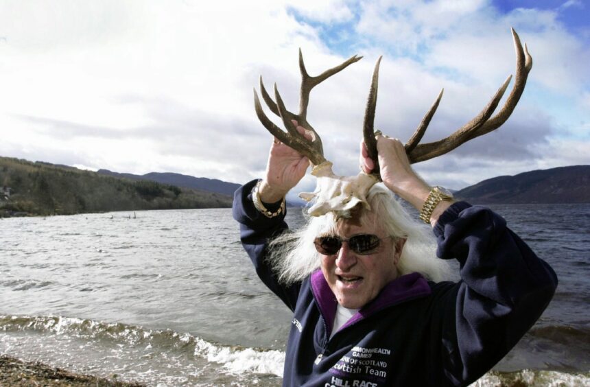 Jimmy Savile wears the horns of a stag on trip to Highlands.