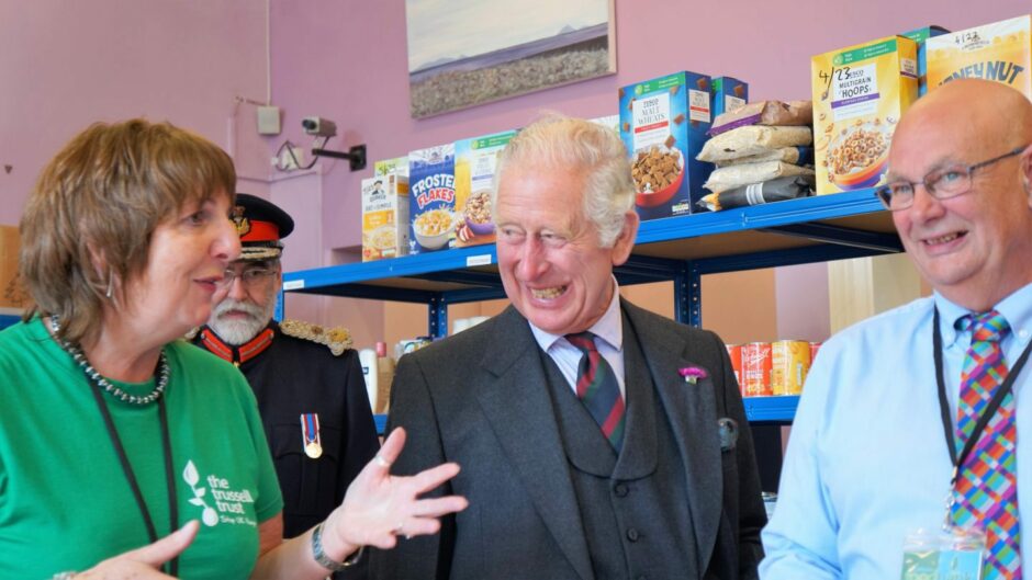 Pat Ramsay and husband Grant with King Charles III at a Wick foodbank last summer.