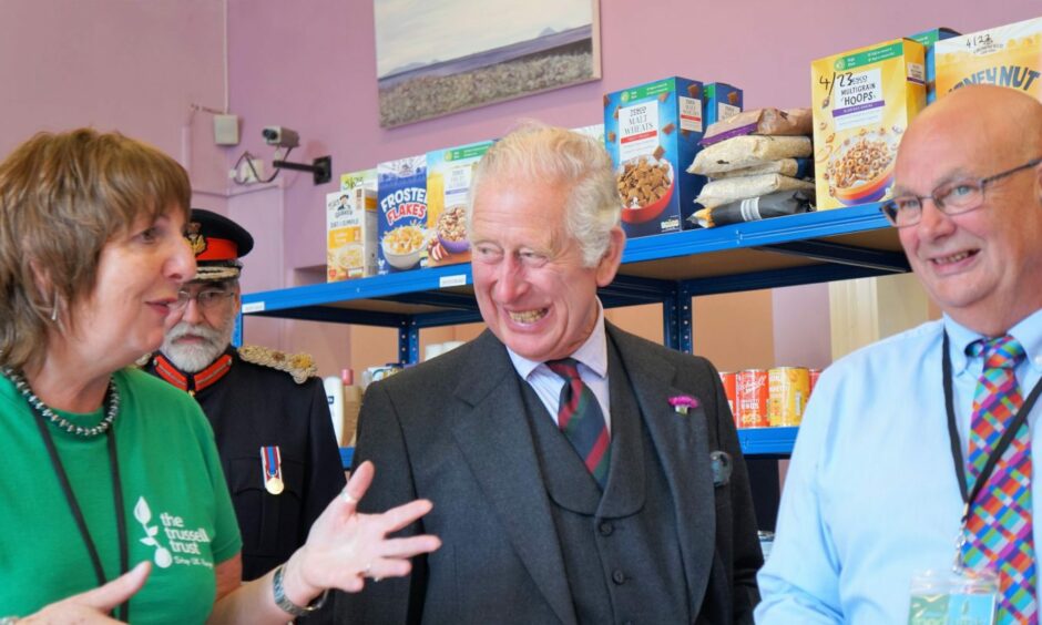 Pat Ramsay and husband Grant with King Charles III at a Wick foodbank last summer.
