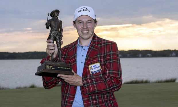 RBC Heritage winner Matt Fitzpatrick holds the championship trophy after his play-off win against Jordan Spieth.