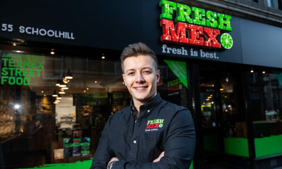 Robbie Moult standing in front of FreshMex's Aberdeen Schoolhill restaurant.