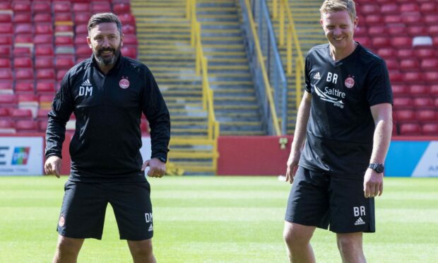 Former Aberdeen manager Derek McInnes oversees training with Barry Robson (right). Image: SNS.