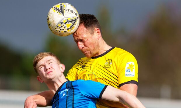 Strathspey Thistle's Jack Davison, left, challenges Gary Warren of Clachnacuddin in the air. Pictures by Jasperimage