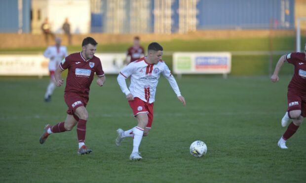 Brechin's Anthony McDonald, centre, tries to get away from Keith's Kieran Yeats, left. Pictures by Wullie Marr