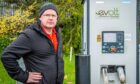 Stephen Brand outside the EV charging point that gave him the unexpected bill. Image: Wullie Marr/ DC Thomson