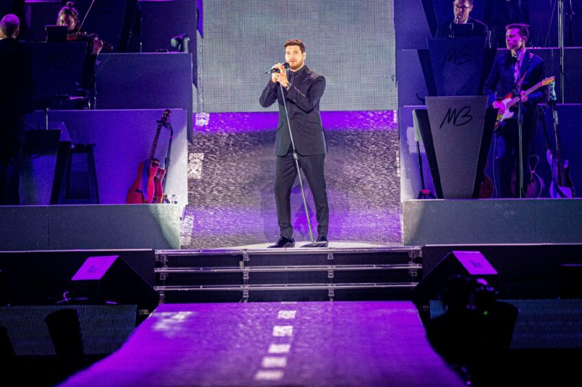 Michael Bublé spotlighted on stage at P&J Live.