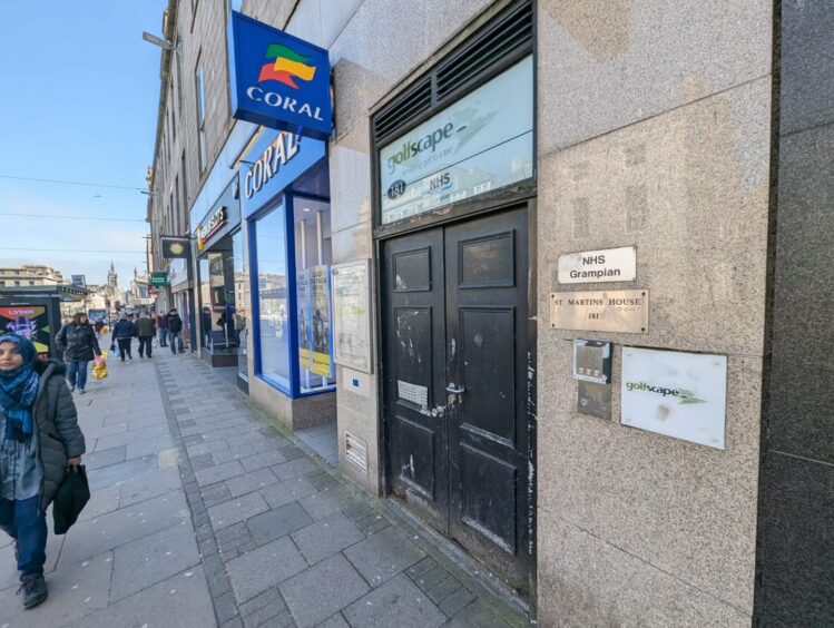 The entrance to the unloved 181 Union Street. The former NHS Grampian office and virtual golfing centre above the Coral betting shop and Merkur Slots premises are to be converted into flats. Image: Alastair Gossip/DC Thomson.
