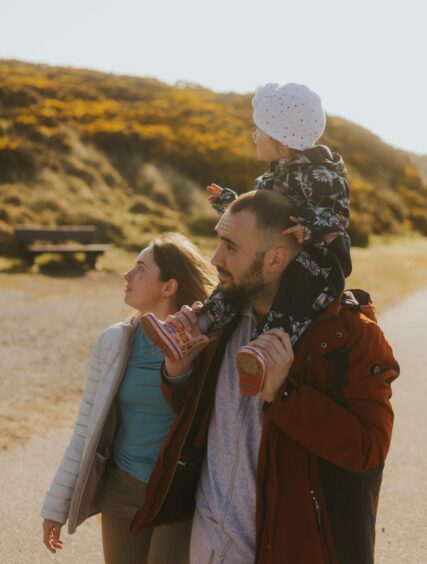 Shown with his baby on his shoulders walking on Balmedie Beach with his wife Yuliia is Artur, a doctor from Ukraine.
