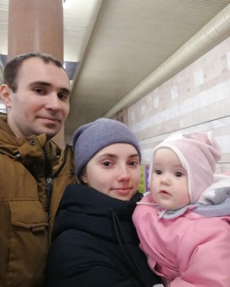 Wearing warm clothes and pictured next to an underground railway line Ukrainian doctor Artur, his wife Yuliia and baby daughter are pictured together for the last time before war separated them. 