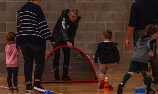 Lossiemouth United launched a little kickers section at the weekend with Lossiemouth FC manager Ian Campbell, centre, among those who helped run it. Image: Lossiemouth United FC