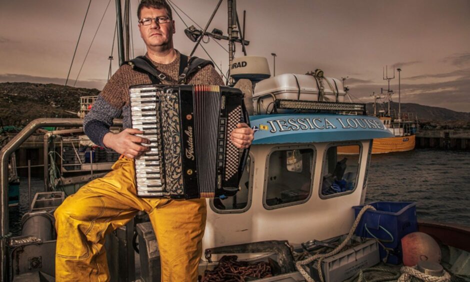 Angus MacPhail of Skipinnish, playing accordion against seaside backdrop.