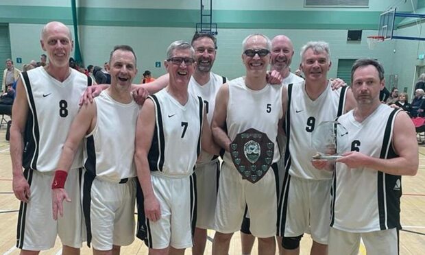 Aberdeen's over-50s basketball team with the Strathclyde Masters Tournament trophy.