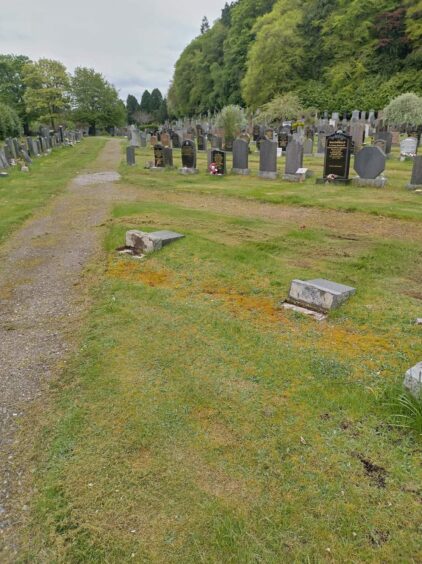 Headstones pushed over at Tomnahurich Cemetery, Inverness.