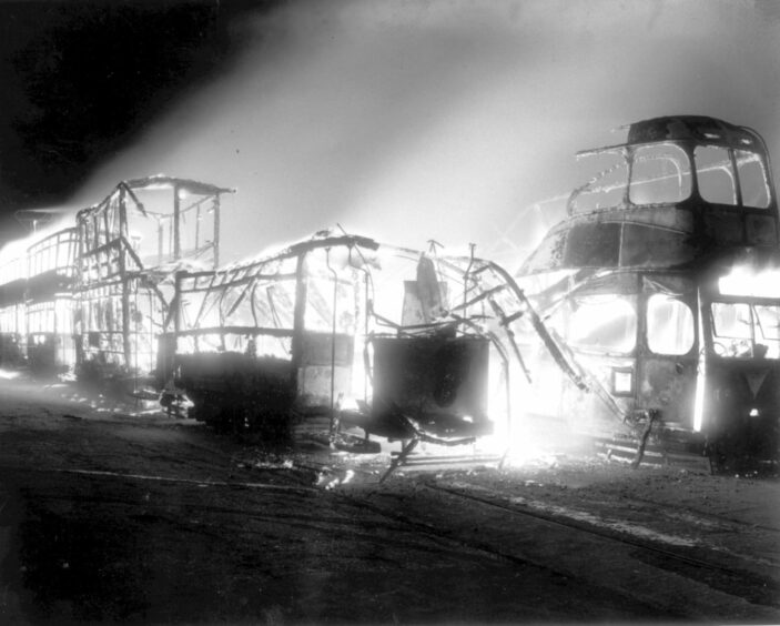 UP IN SMOKE: The cordiality quickly came to an end as ideas like the Aberdeen cable car and tram revival were discussed. In 1958, 70,000 gathered at the beach to watch tram cars go up in flames. Image: DC Thomson.