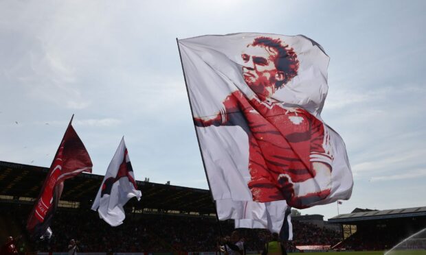 A flag in memory of Neale Cooper is flown at Pittodrie before Aberdeen's match with Hibs. Image: Shutterstock.