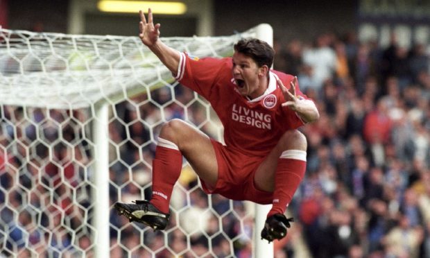 Aberdeen's Dean Windass celebrates a John Inglis goal against Rangers at Ibrox. Image: SNS.