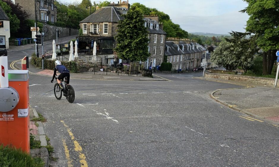 Mr Page rides past The Castle Tavern as he begins his world record attempt.