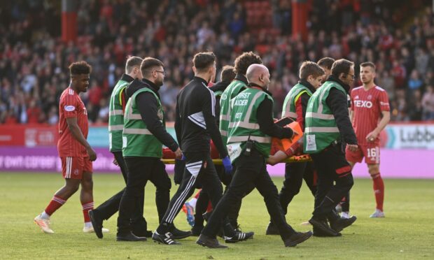 Aberdeen striker Bojan Miovski is stretchered off with an ankle injury against  St Mirren. Photo Darrell Benns/ DCT Media