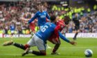 Rangers' Connor Goldson (L) grapples with Aberdeen's Duk as he advances into the box at Ibrox. Image: SNS.