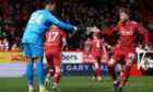 Aberdeen's Hayden Coulson celebrates with keeper Kelle Roos after he saved a penalty from Hibs' Kevin Nisbet. Image: SNS.