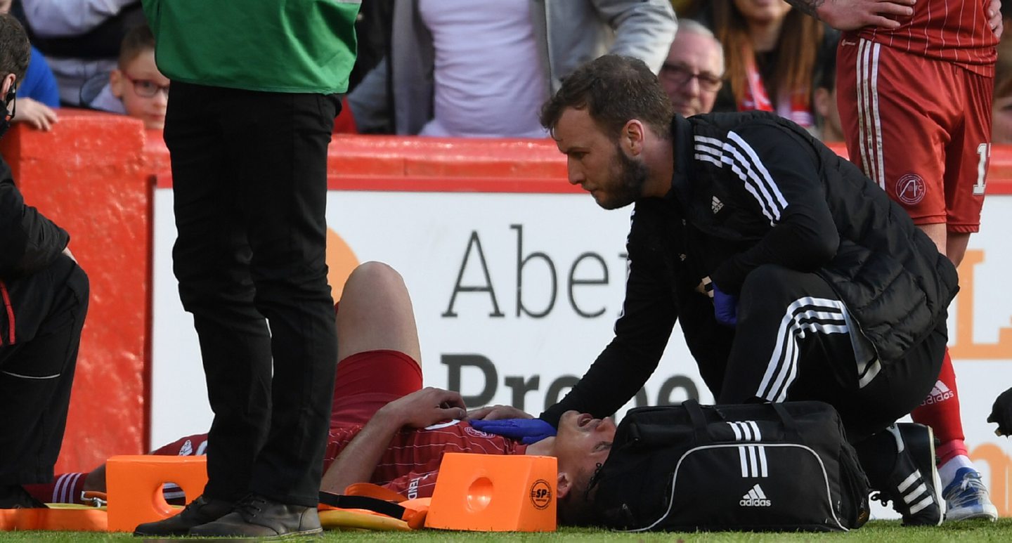 Aberdeen's Bojan Miovski receives treatment after a tackle by Thierry Small in game against St Mirren in May.