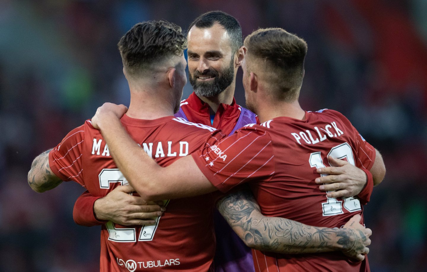 Aberdeen's Joe Lewis, Angus MacDonald and Mattie Pollock celebrate as the club are guaranteed European football group stages next season after beating St Mirren 3-0.