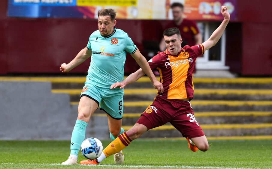 Motherwell's Lennon Miller and Dundee United's Peter Pawlett during a cinch Premiership match in May 2023.