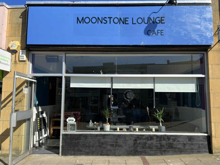 The exterior of Moonstone Lounge with the door open for customers