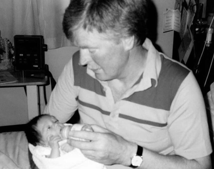 Jason McClurg as a baby with his Father David.