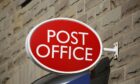 Post Office sign on building.