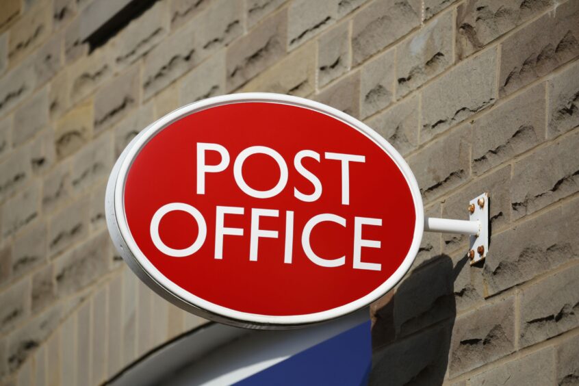Post Office sign on building.