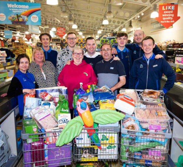 Westhill aldi Supermarket Sweep winner and staff with three trolleys of goods