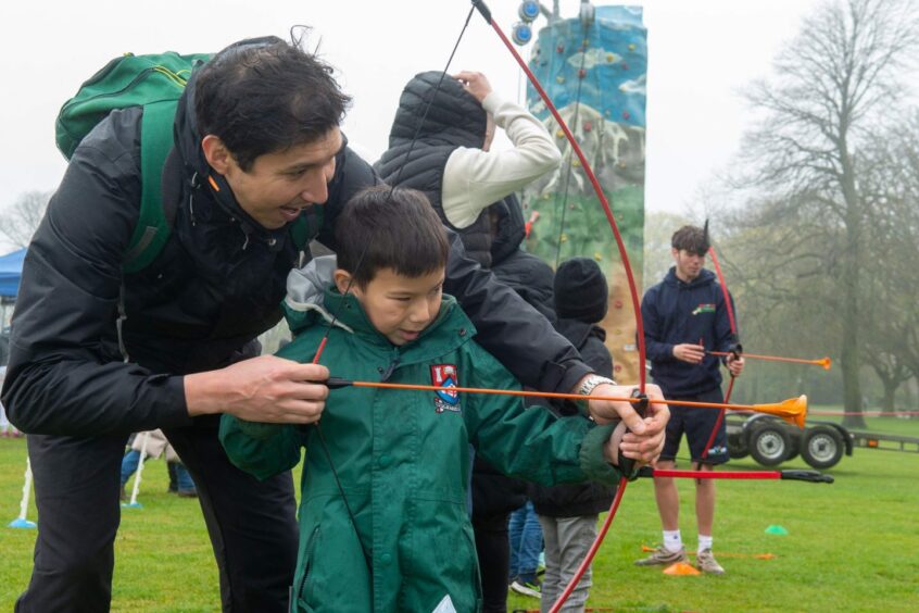 Yerbol and Dias Kurmashev enjoy archery at the event in Duthie Park.
