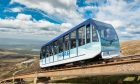 The funicular operating amidst the vast backdrop of the Cairngorms.