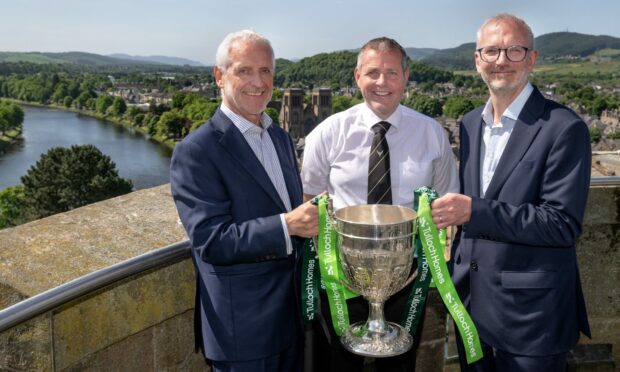 Sandy Grant, left, of Tulloch Homes, Camanachd Association president Steven MacKenzie, centre, and Innes Smith of Springfield Properties with the Camanachd Cup at Inverness Castle