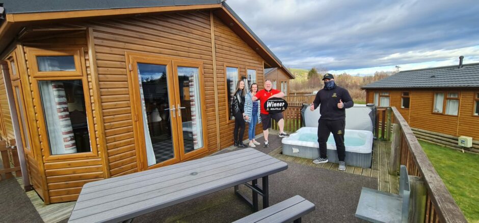 Ian Lemon poses in front of holiday home with a hot tub he won in a Bounty Competitions live draw