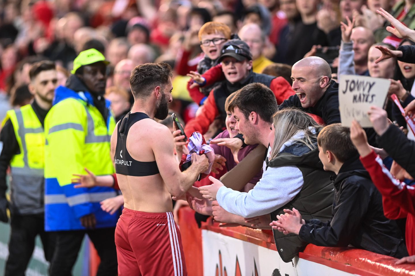 Captain Graeme Shinnie giving away his shirt to a fan in the crowd after securing European qualification