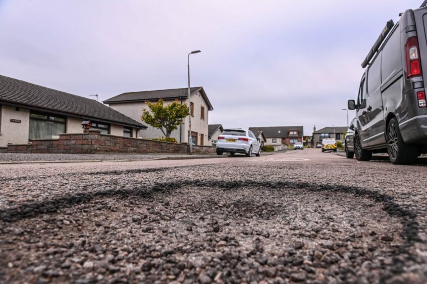 The potholes on a Peterhead street look massive, but Aberdeenshire Council say they will not be fixed until next year.