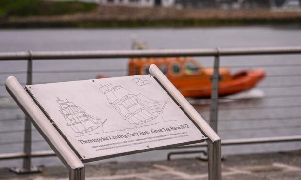 The plaque with a lifeboat in the background