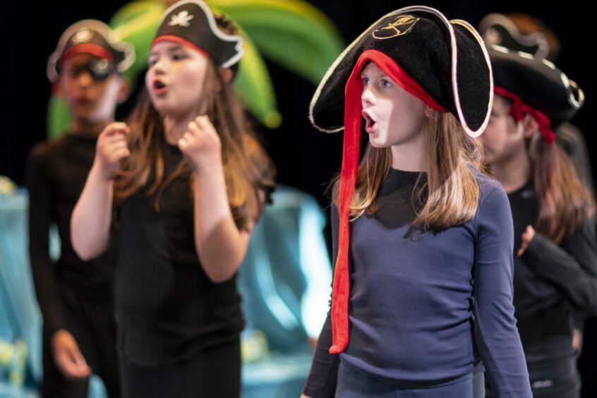 Scottish youngsters performing a play while dressed as pirates.
