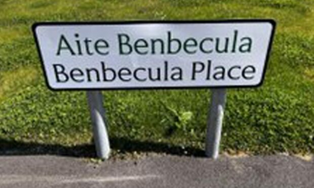 The sign reads Aite Benbecula and Benbecula Place which is not a translation of the name Benbecula.