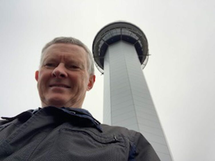 A selfie of Stuart Milne in front of the Northern Lights Tower in Aberdeen