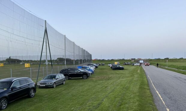 A grassy area near Aberdeen Beach with a number of cars parked