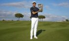 Adrian Meronk holds the trophy after winning the final round of the Italian Open. Image: PA