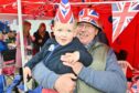 Three-year-old Sam Mackay with his grandad Les Foreman  enjoying quality time together at the street party in Buckie. Image: Jason Hedges/ DC Thomson.