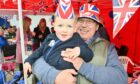 Three-year-old Sam Mackay with his grandad Les Foreman  enjoying quality time together at the street party in Buckie. Image: Jason Hedges/ DC Thomson.